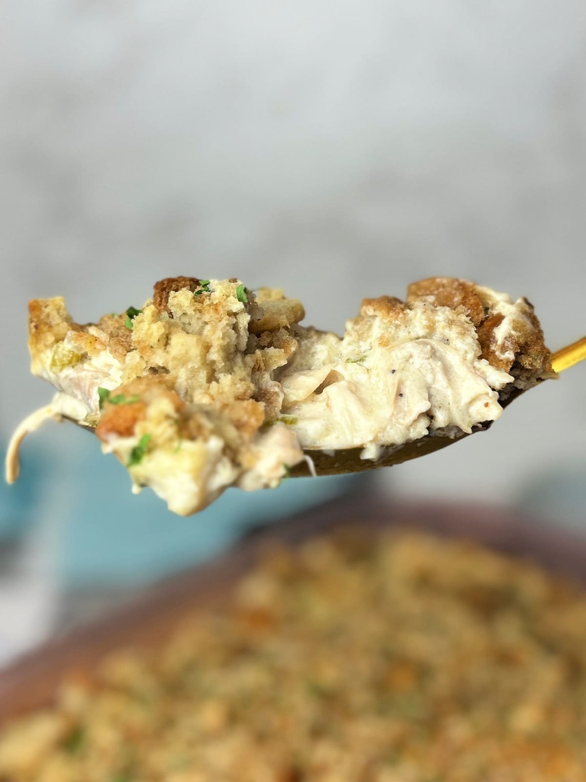 spoonful of chicken and stuffing casserole on a spoon.