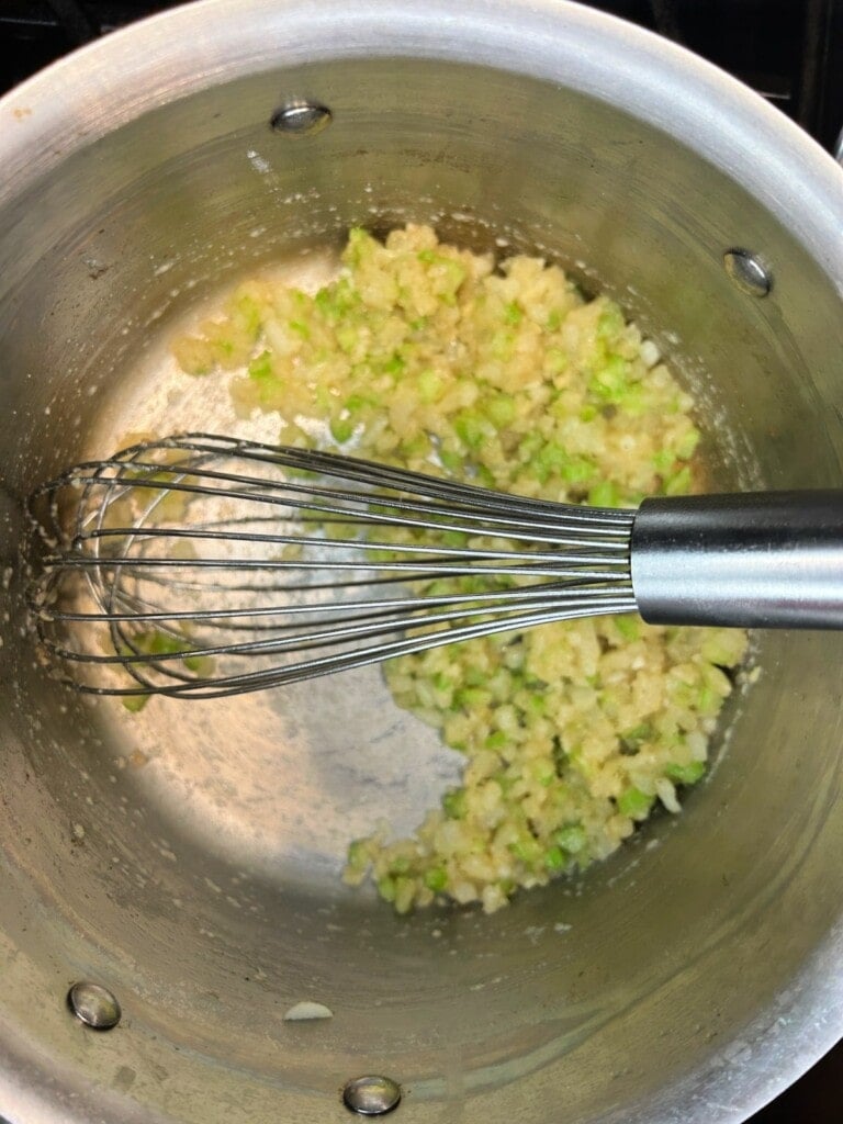 onions and celery sautéing in a pan