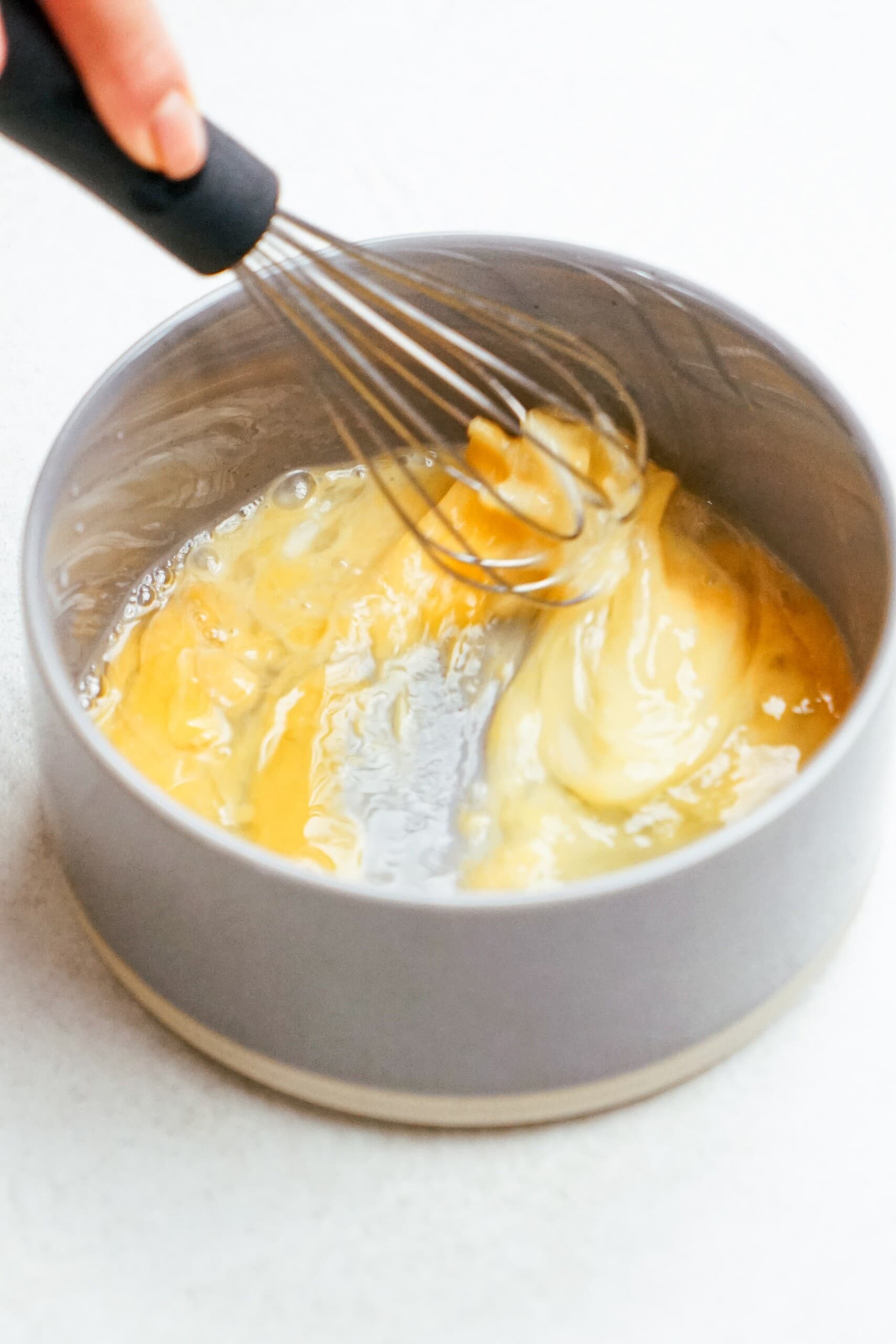 whisk stirring eggs in a small bowl