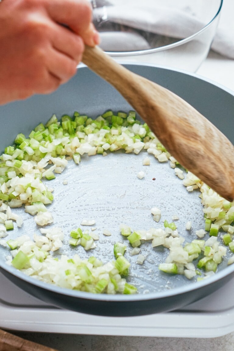 sautéing onions and celery in a skillet