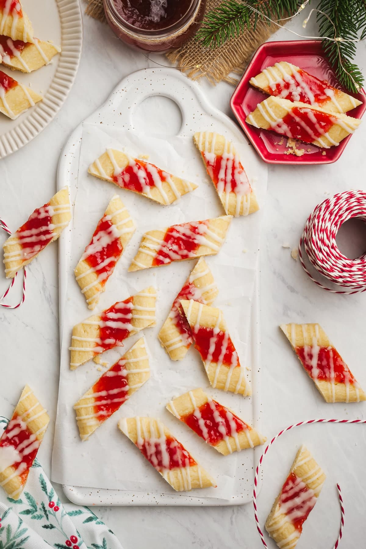 christmas shortbread cookies cut and spread out on a cutting board