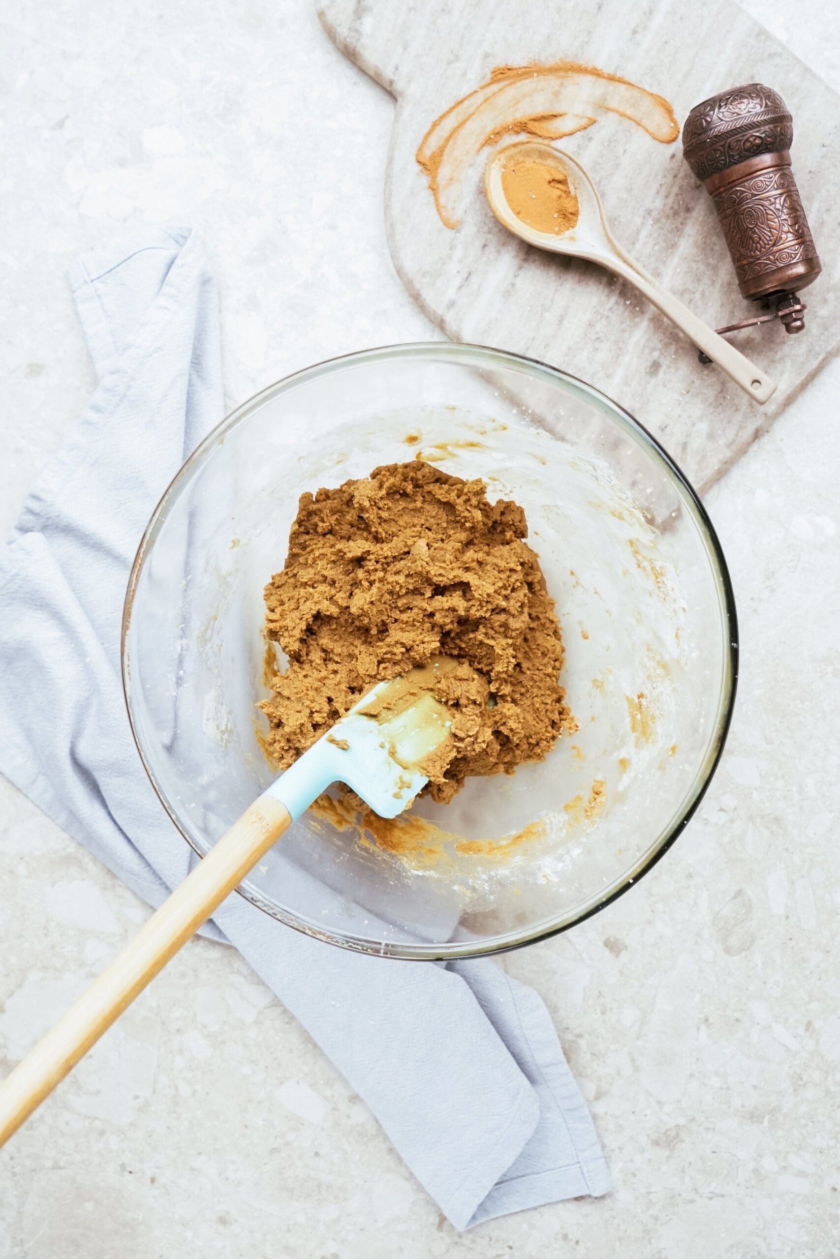 gingerbread dough in a glass bowl with rubber spatula