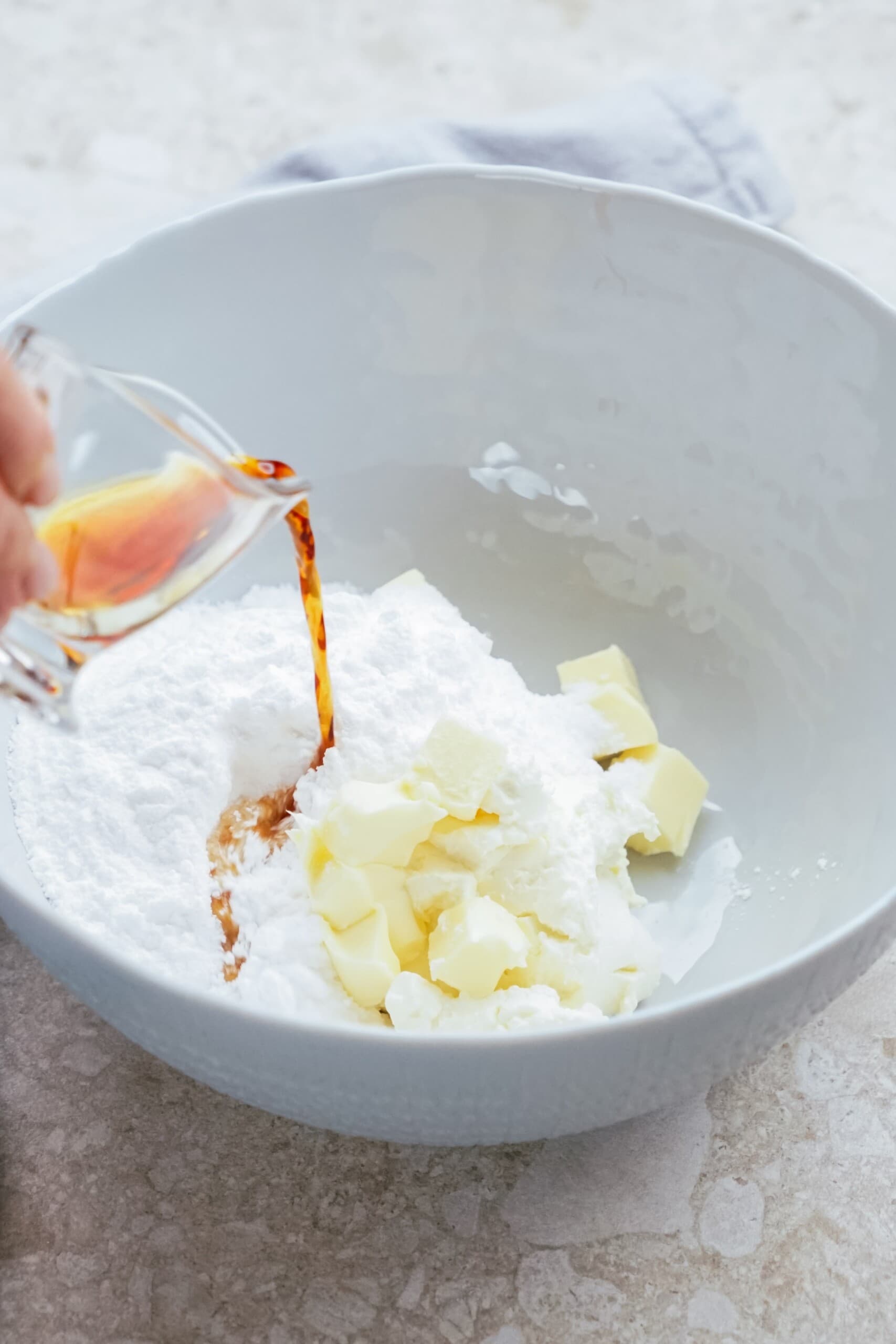 cream cheese frosting ingredients in a bowl