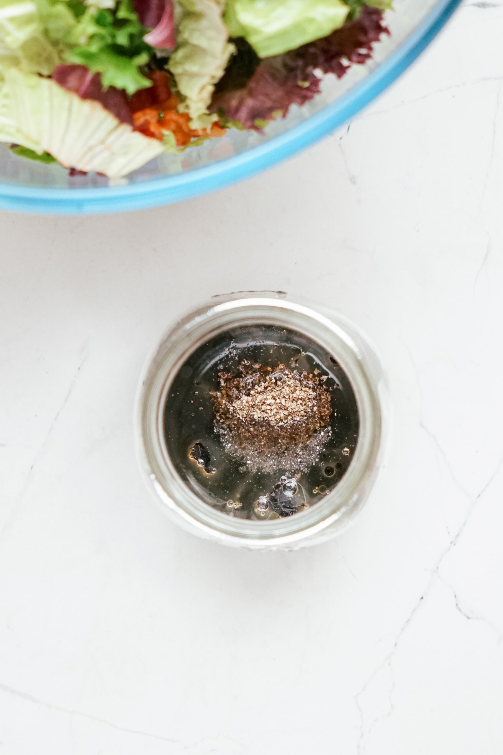 salt and pepper added to salad dressing jar 