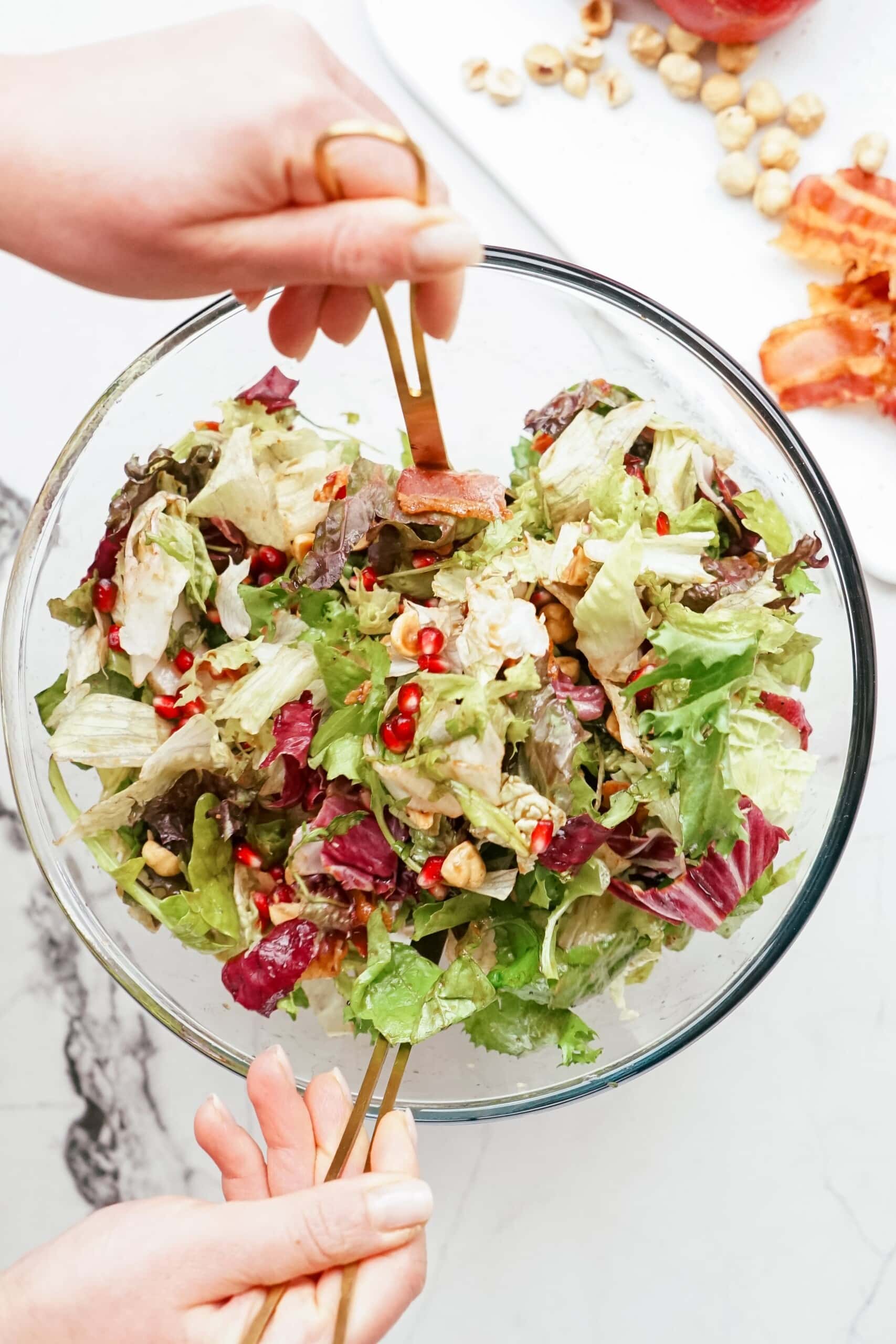 tossing salad and dressing together
