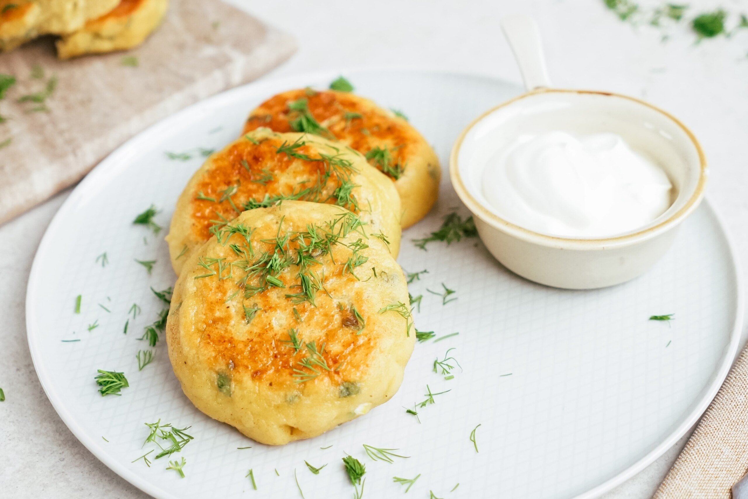 potato patties on a plate with dipping sauce