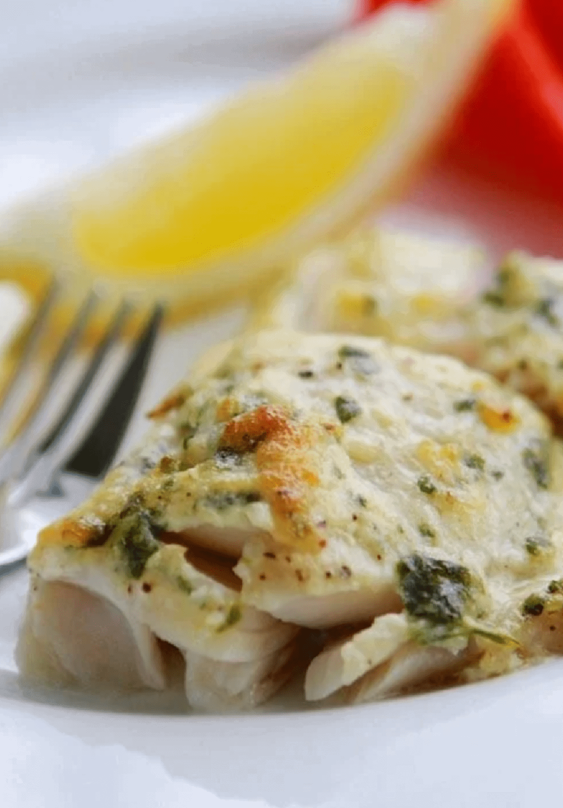 Baked Cod on plate with lemon and fork