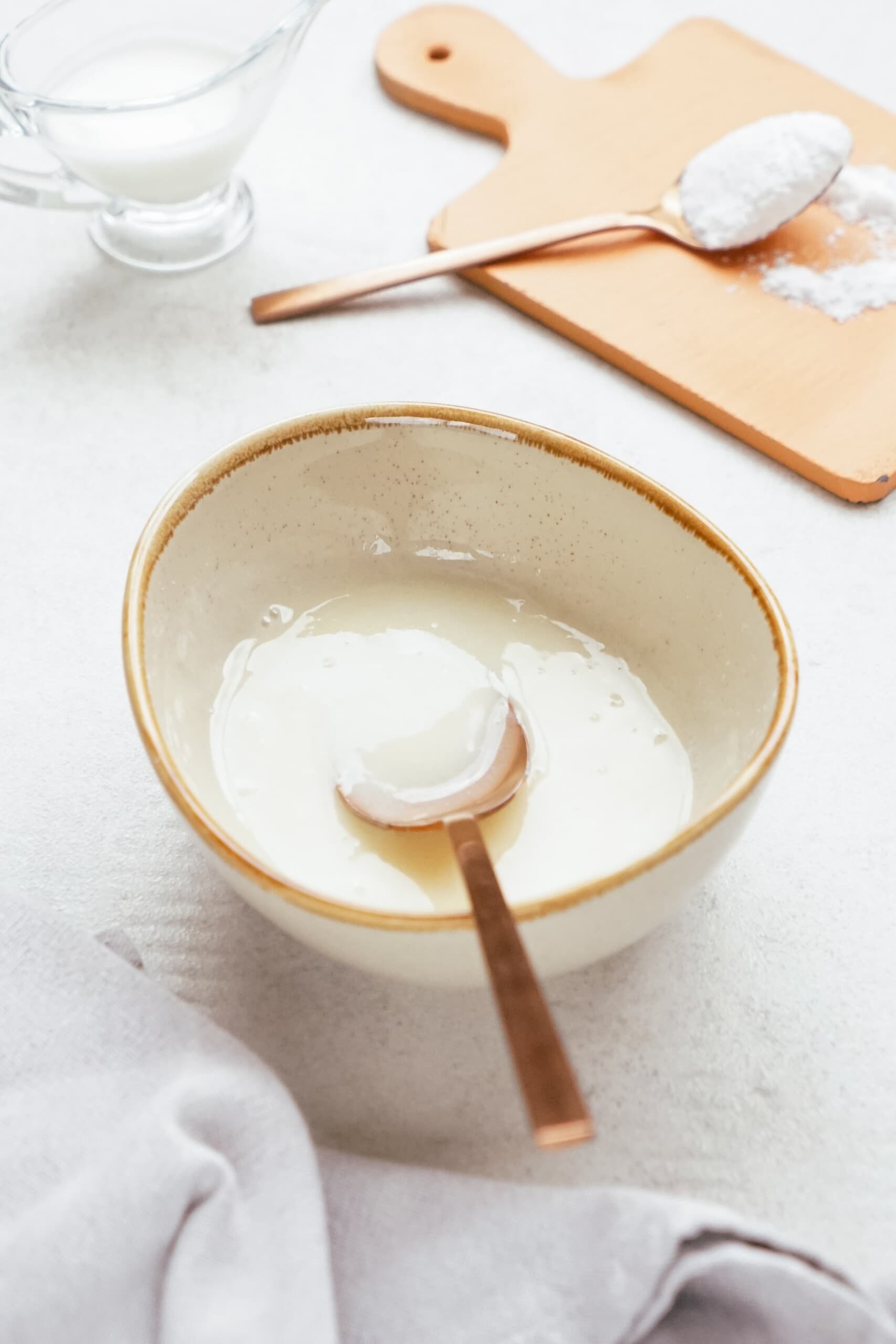 yogurt glaze in a bowl with a gold spoon