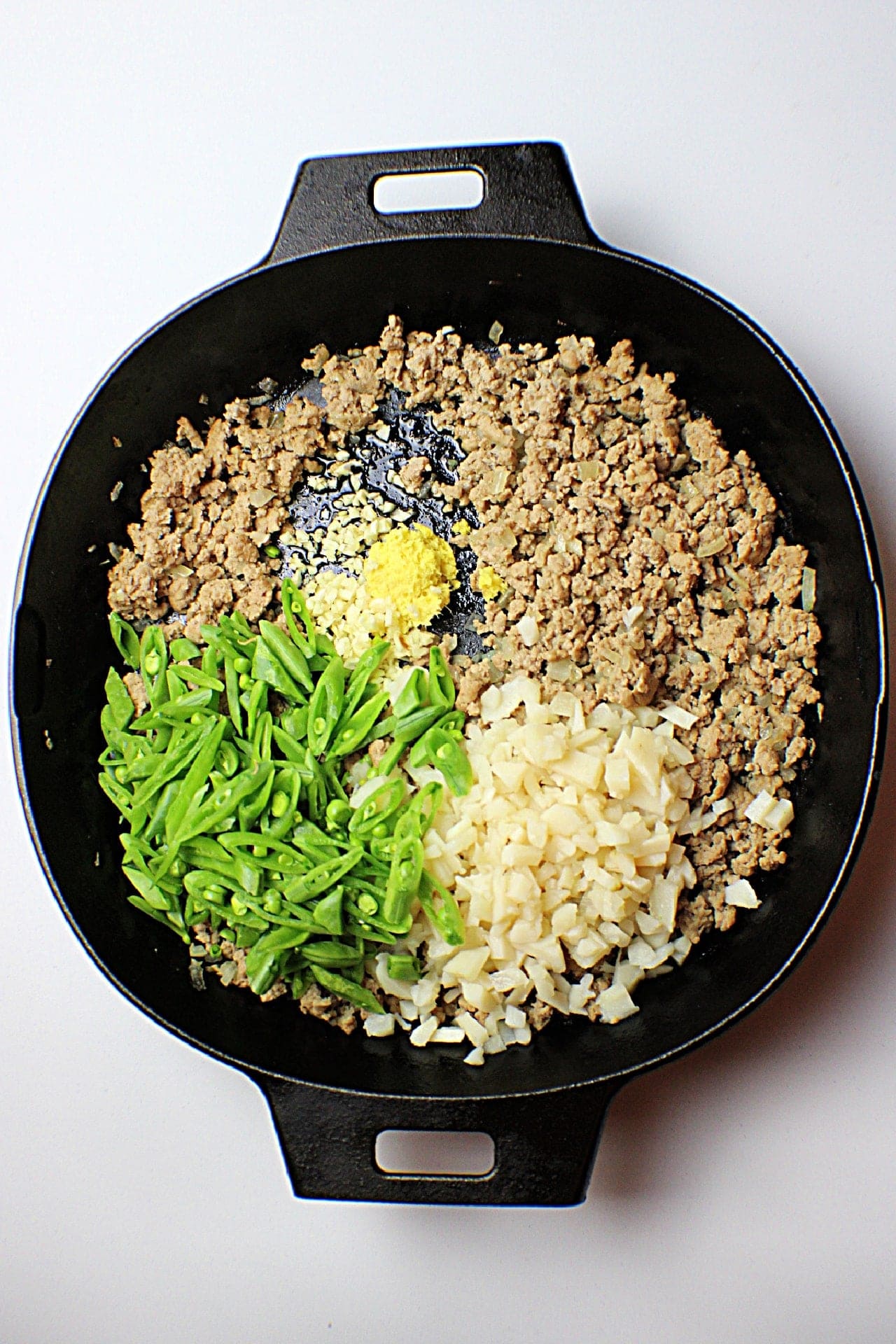 Ground Turkey in a skillet with snap peas, water chest nuts