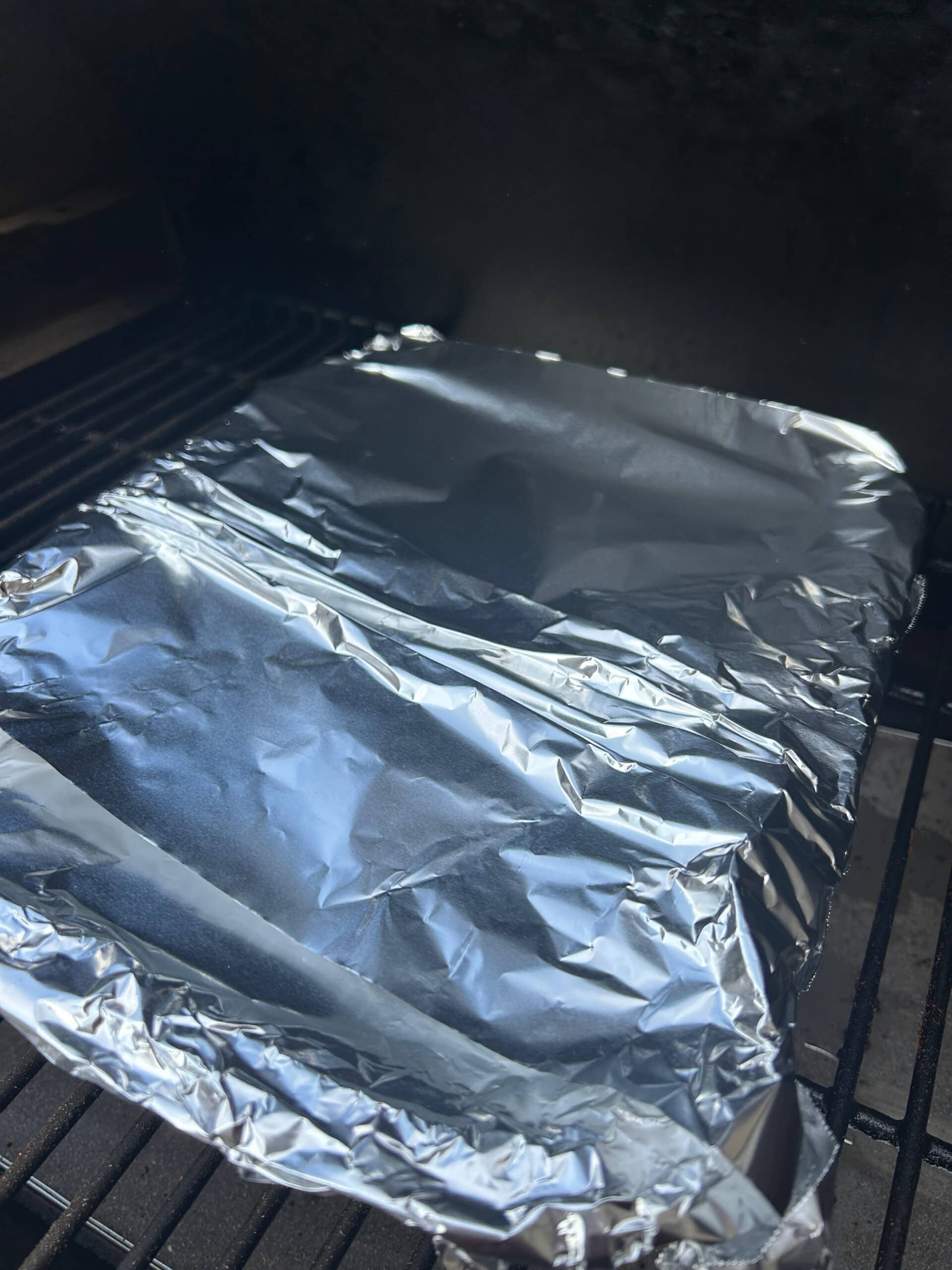 Smoked Arm Roast covered with foil in the smoker 