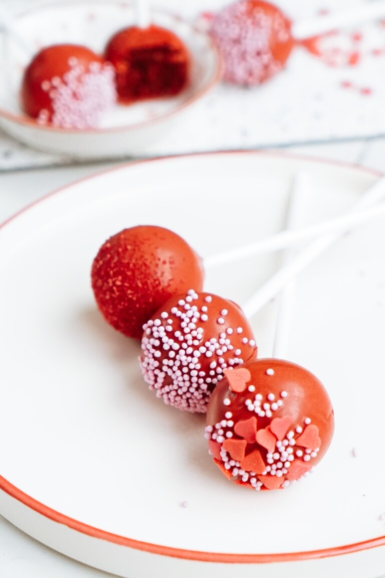 3 red cake pops on a plate