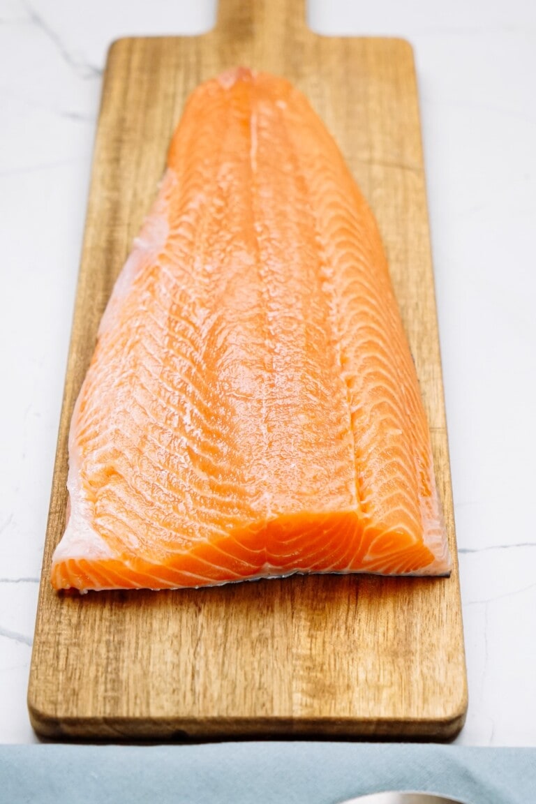 large salmon fillet on a cutting board