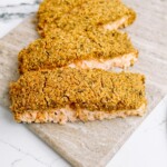 baked salmon fillets on a cutting board