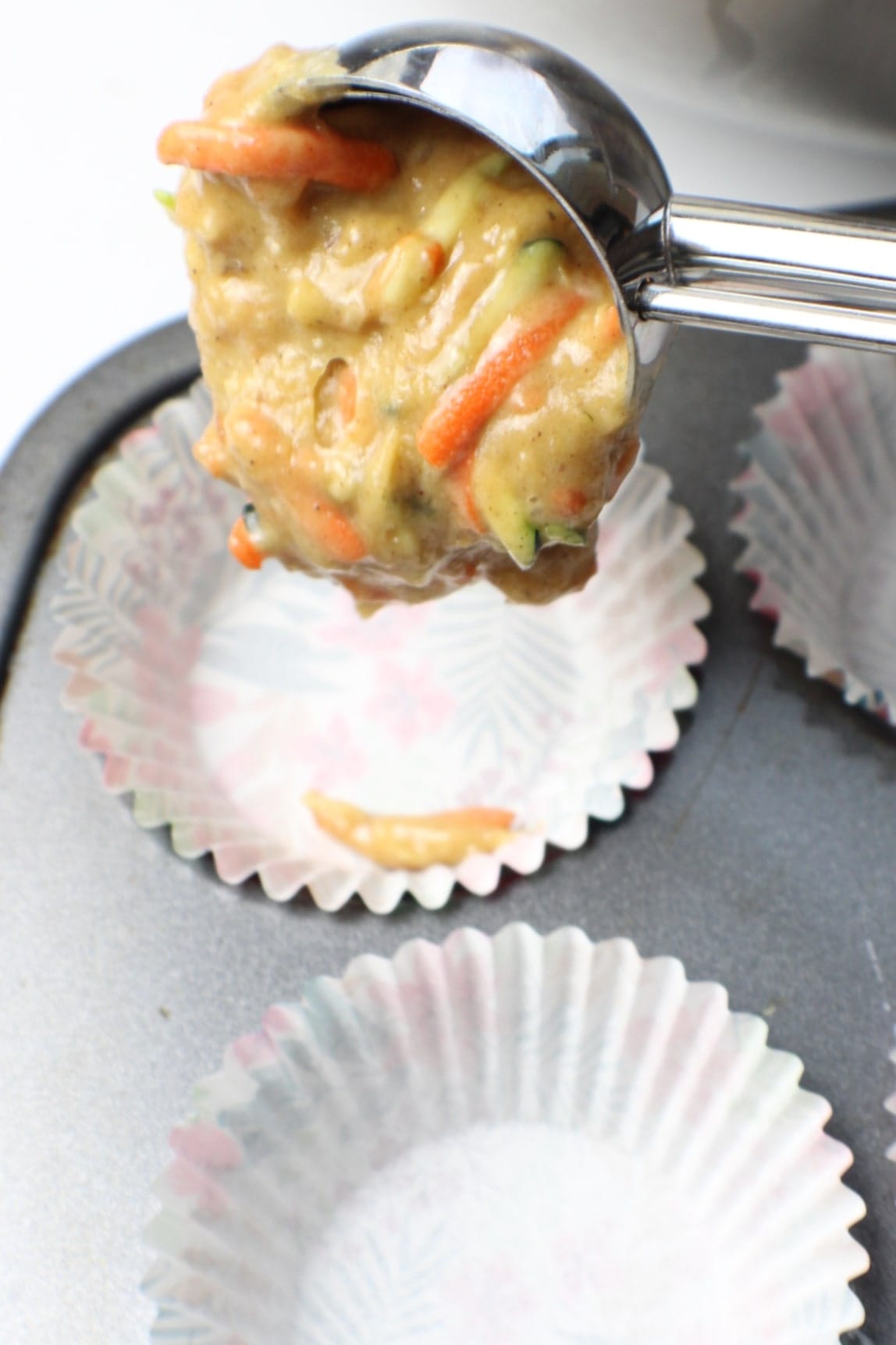 Morning Glory Muffins batter scooped into muffin tin