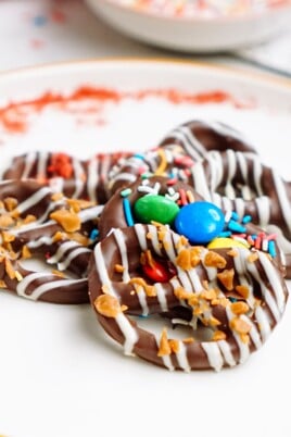 Chocolate pretzels with sprinkles on a plate.
