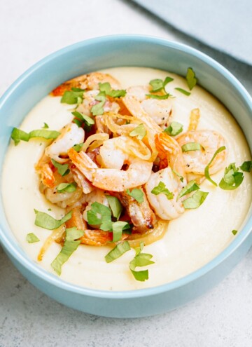 A bowl of food with shrimp and grits.