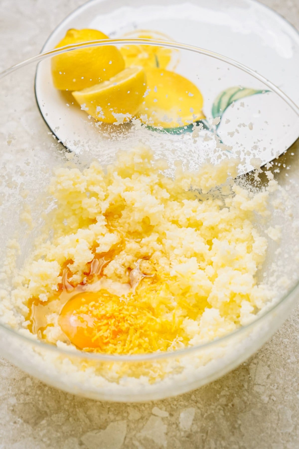 Ingredients in a bowl for baking, including flour and eggs, with a whisk on top.