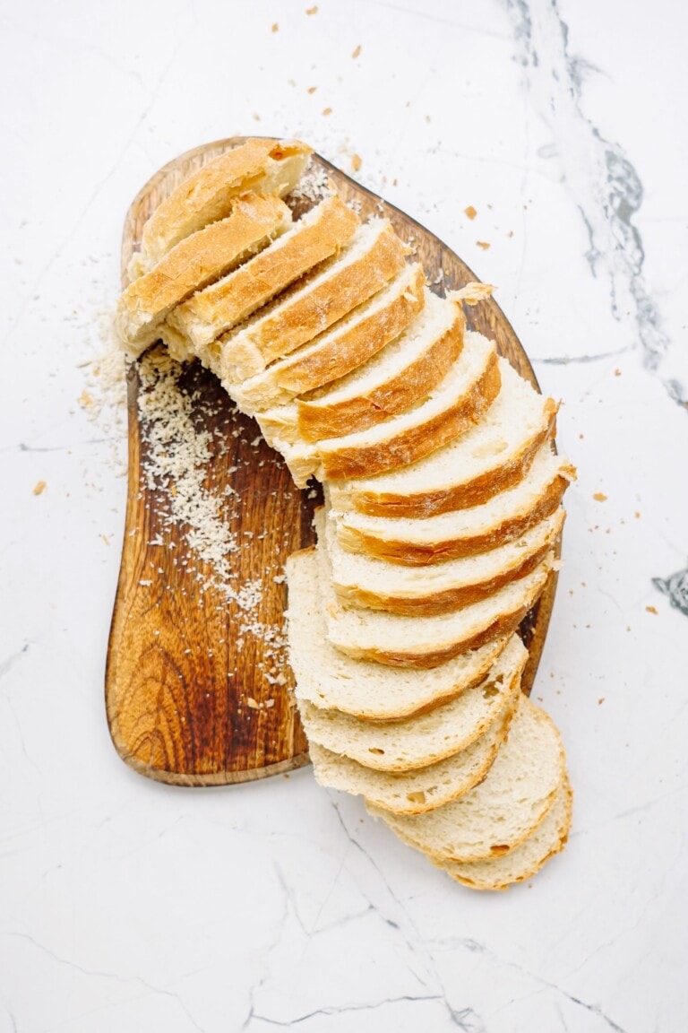 Sliced bread on a wooden cutting board for breakfast.