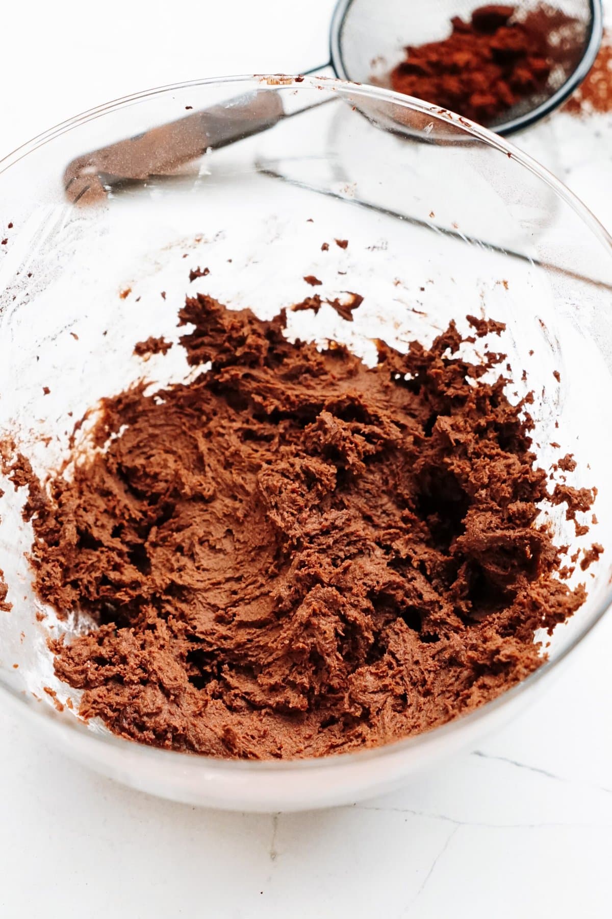 A bowl filled with chocolate frosting