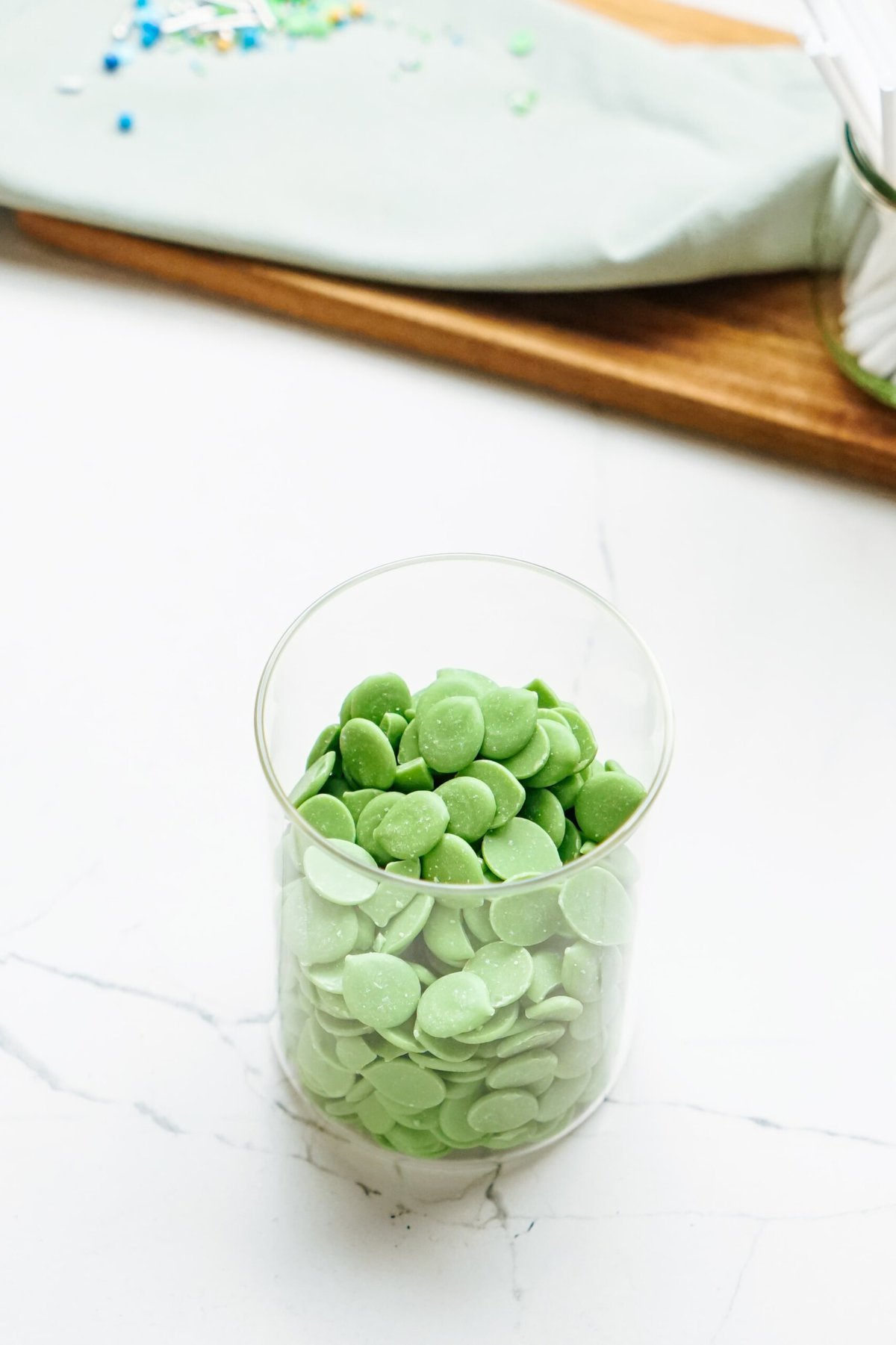 Green chocolate wafer melts in a glass bowl.