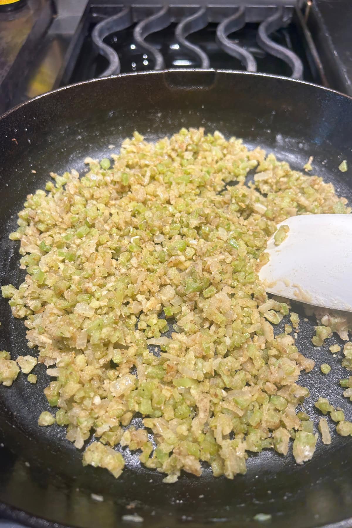 onions and celery sautéing in a pan