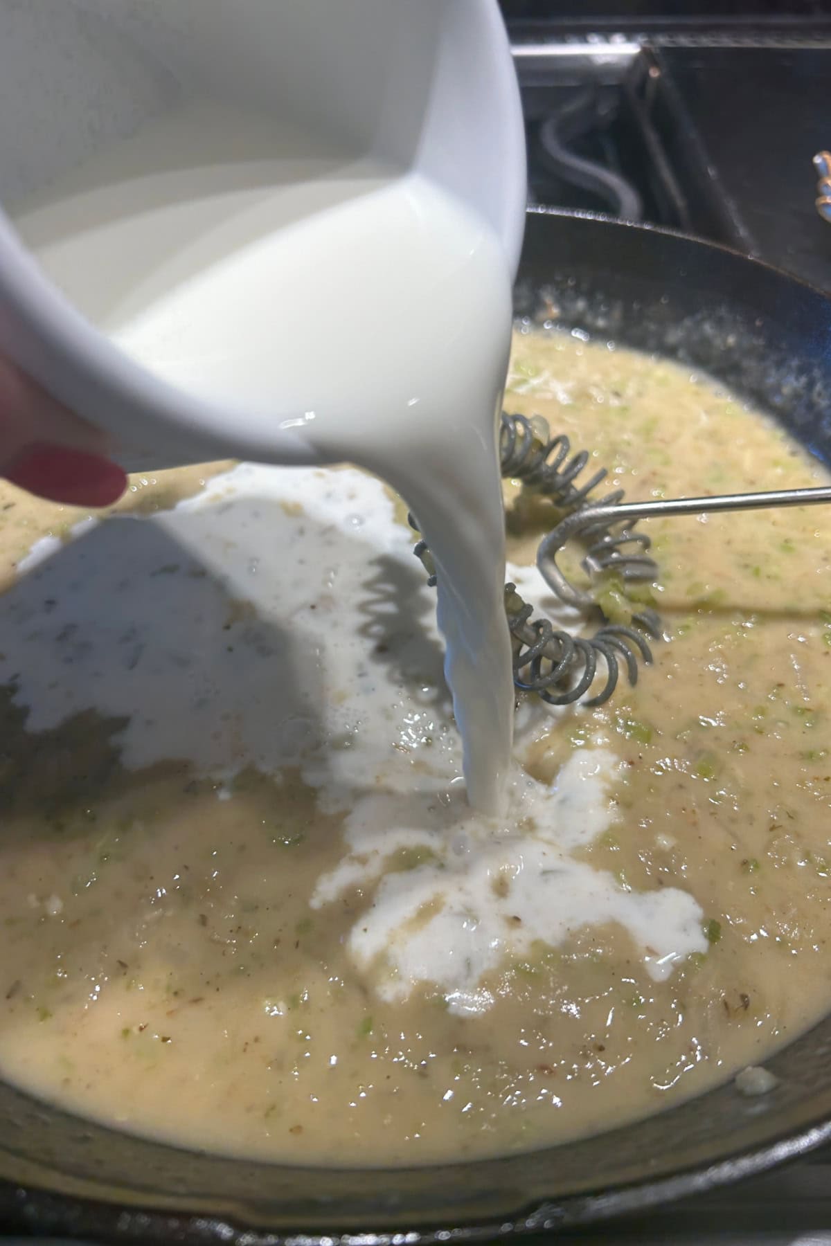 adding milk to the roux mixture 