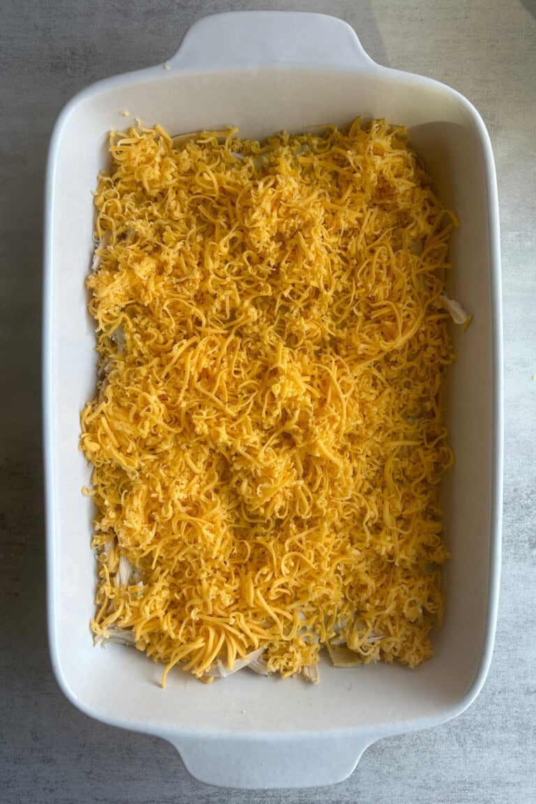 shredded cheddar added to sauce layer