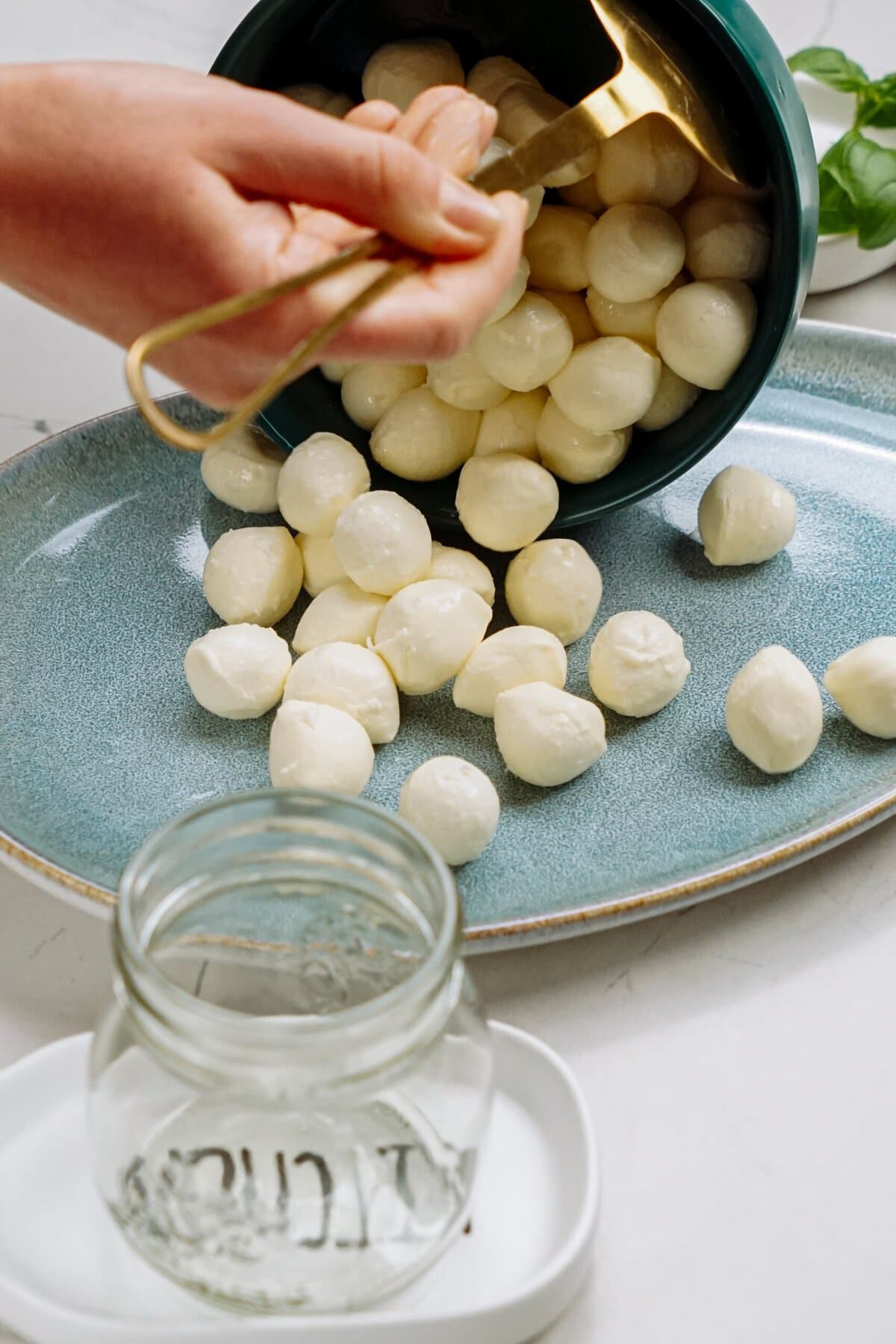mozzarella balls being poured onto a plate