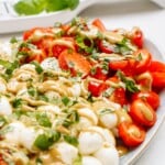 caprese salad with dressing drizzled over