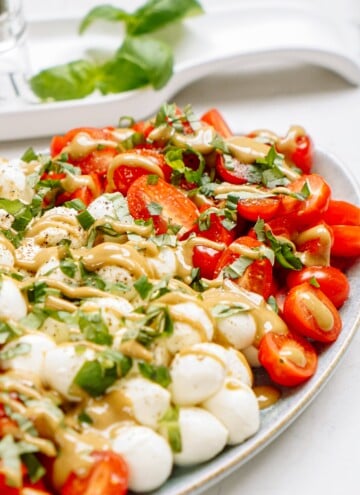 caprese salad with dressing drizzled over