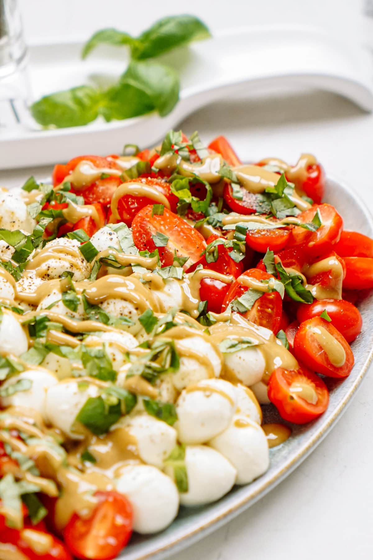 caprese salad with dressing drizzled over 