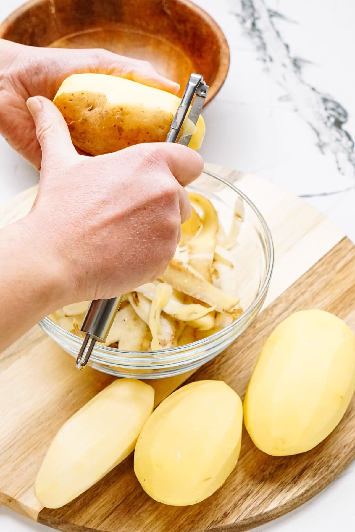 a person peeling potatoes