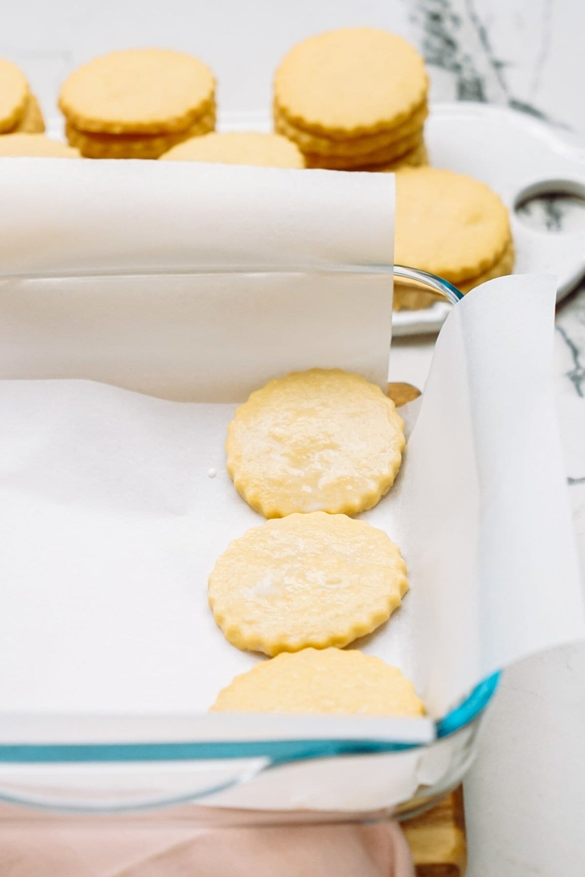Shortbread cookies on parchment paper in a metal baking tray.