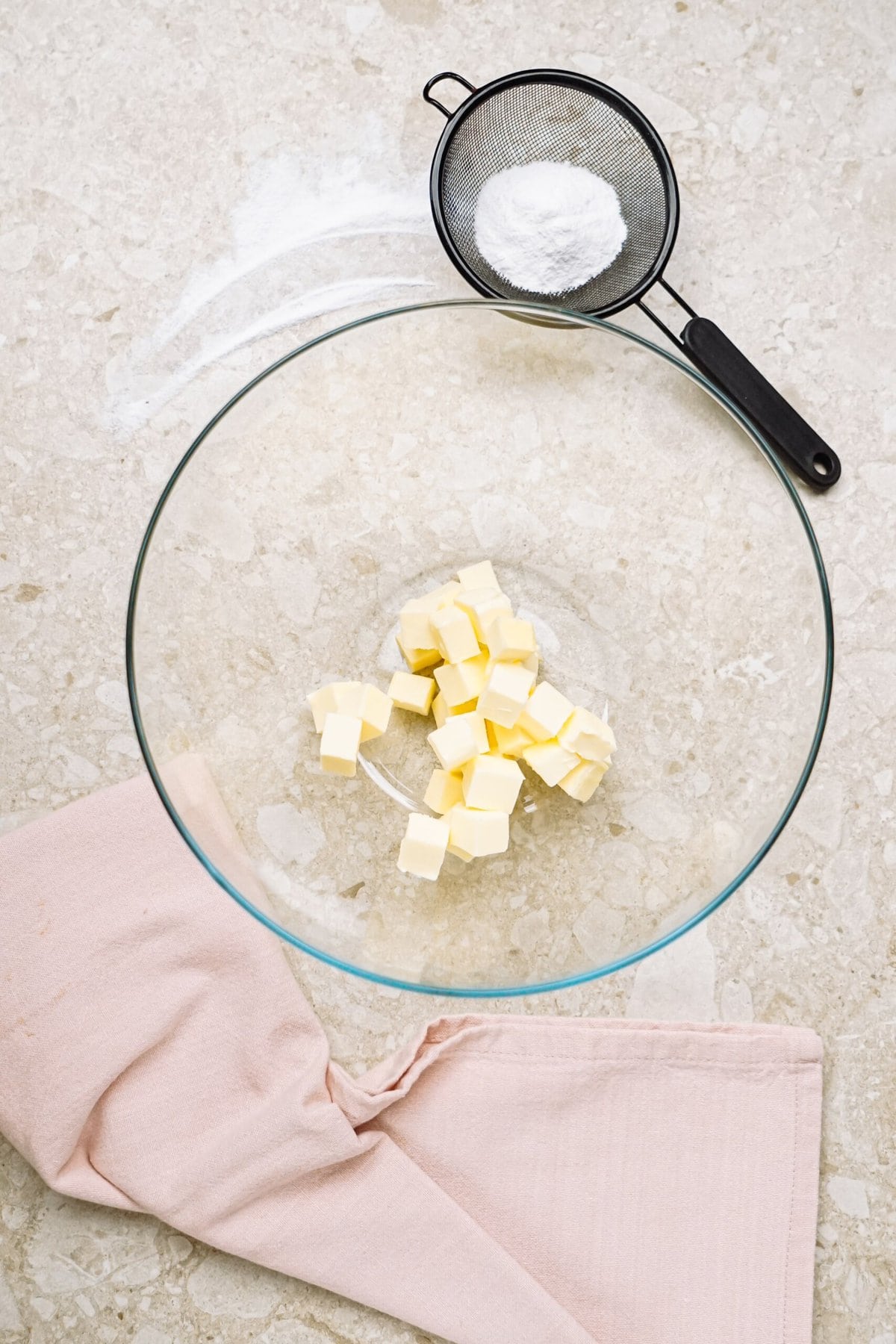 butter cut into squares in a glass bowl
