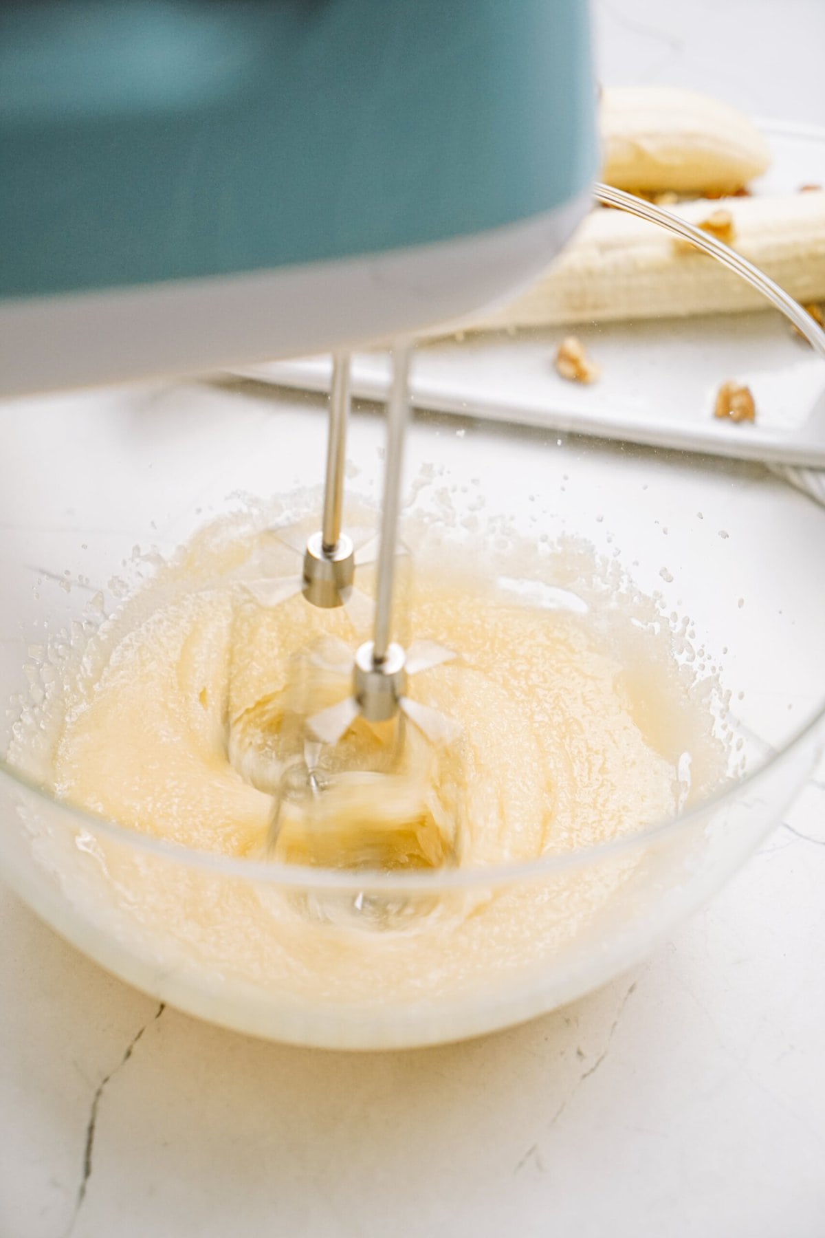 whisking cake batter in a glass bowl 