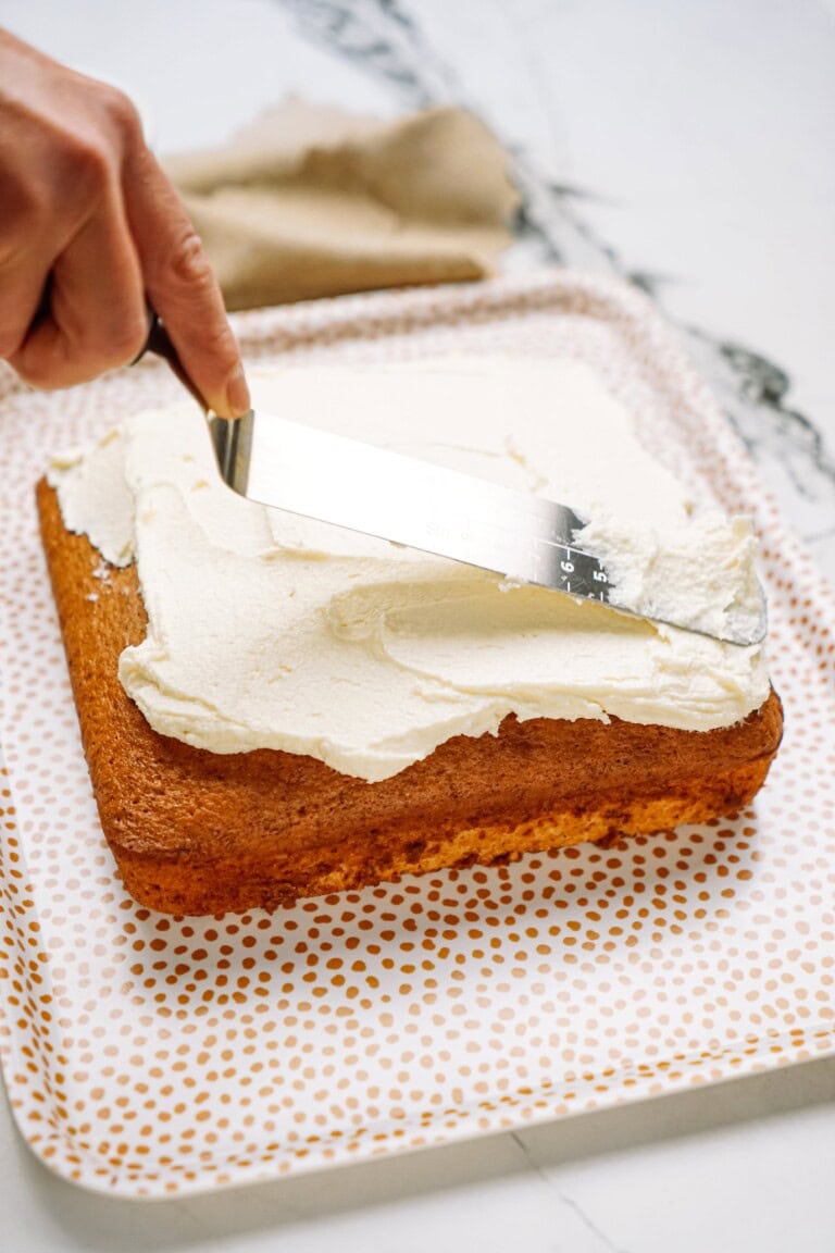 a person frosting a cake
