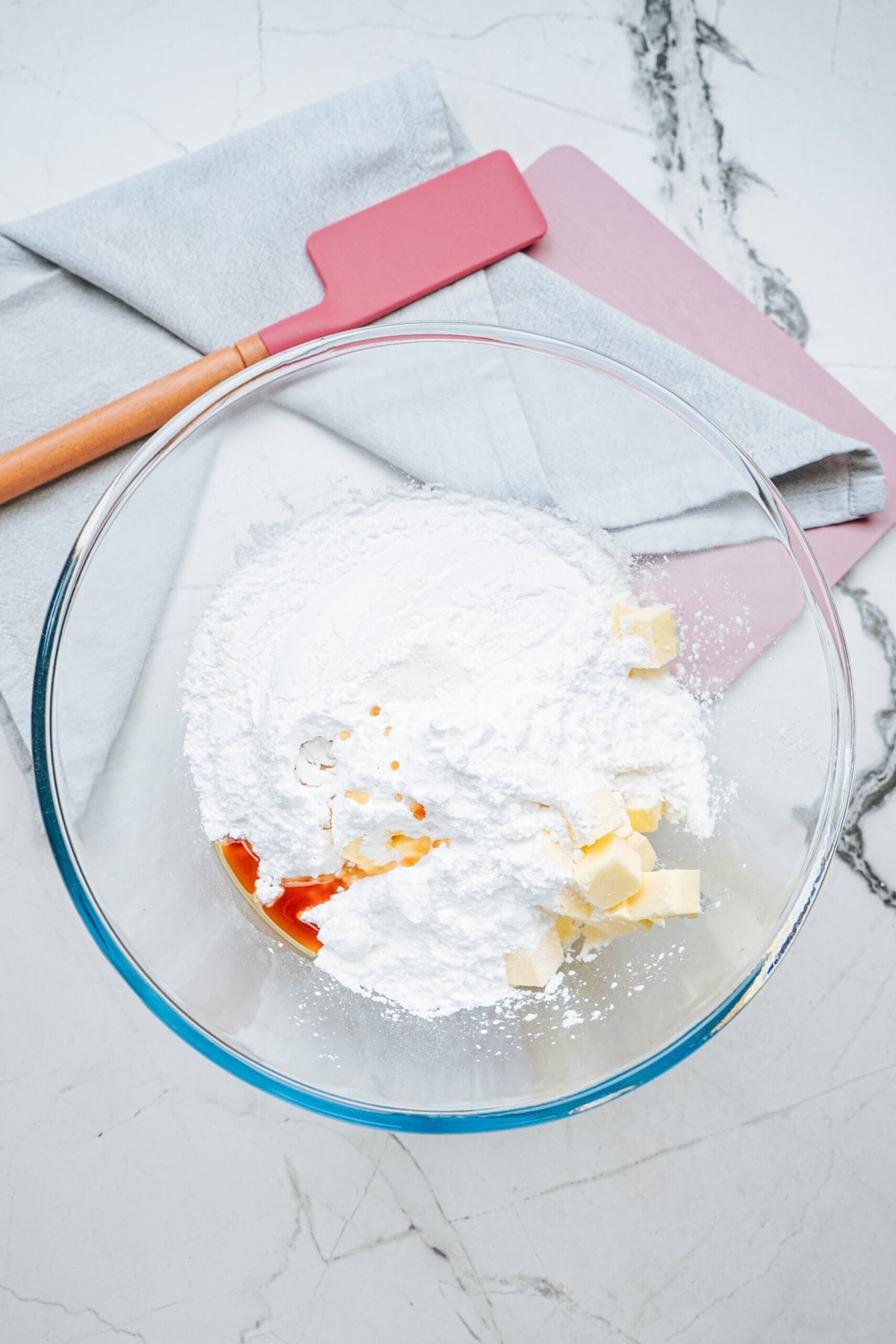 frosting ingredients in a glass mixing bowl 