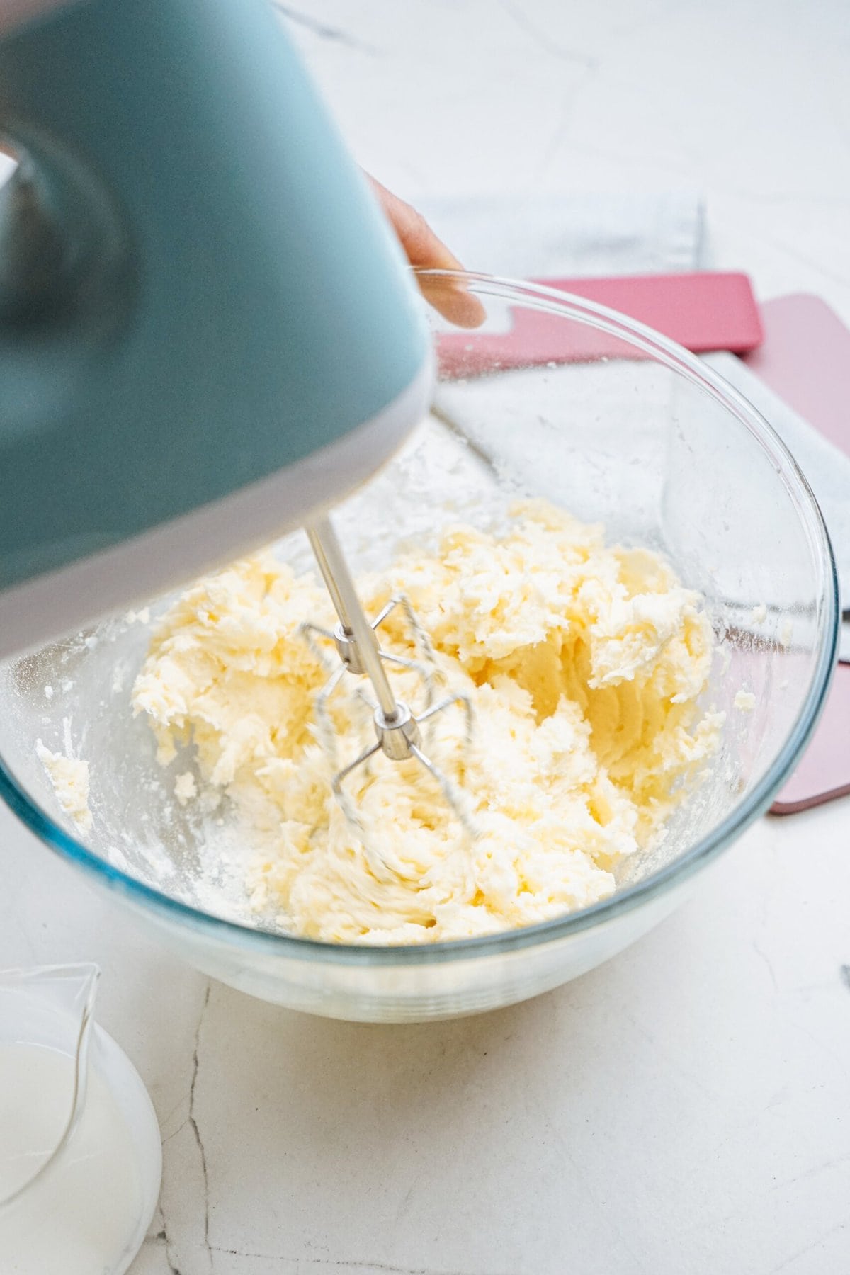 electric mixer whipping frosting together 