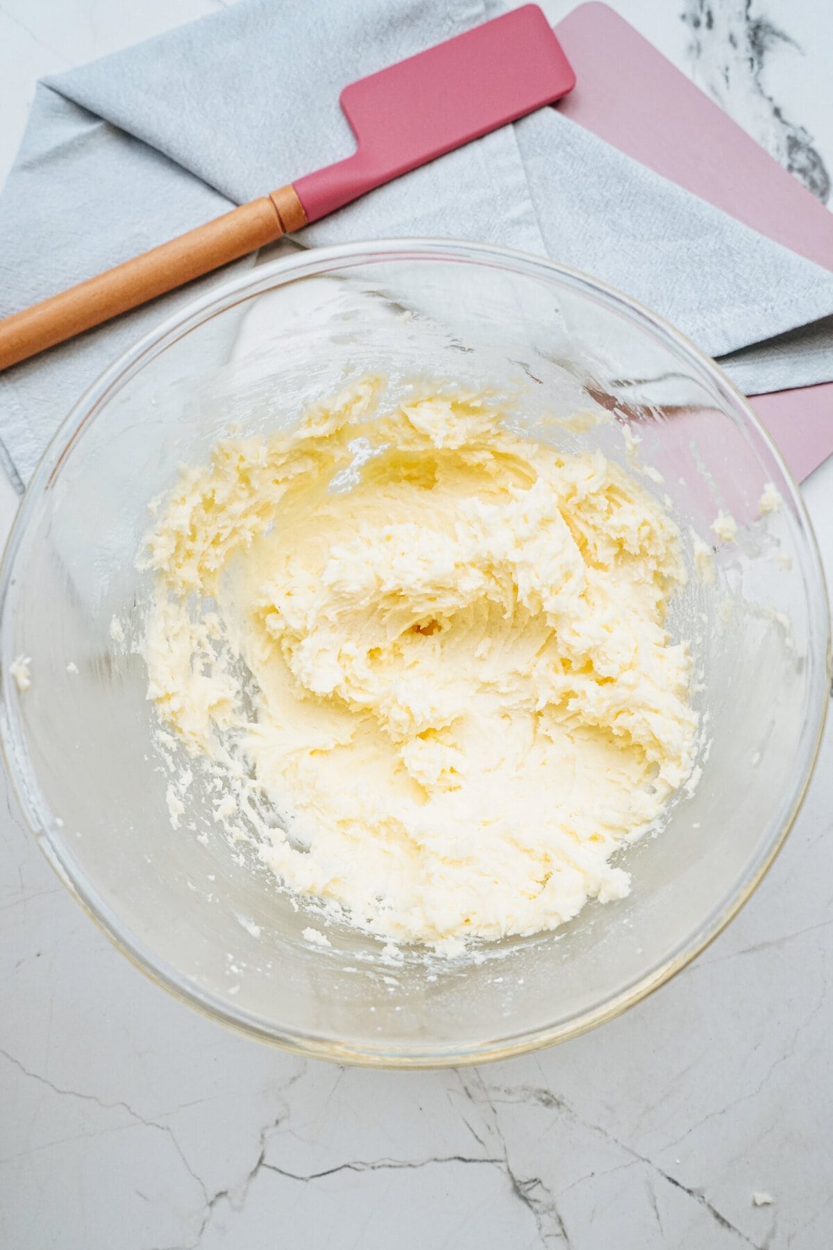 vanilla frosting in a glass mixing bowl 
