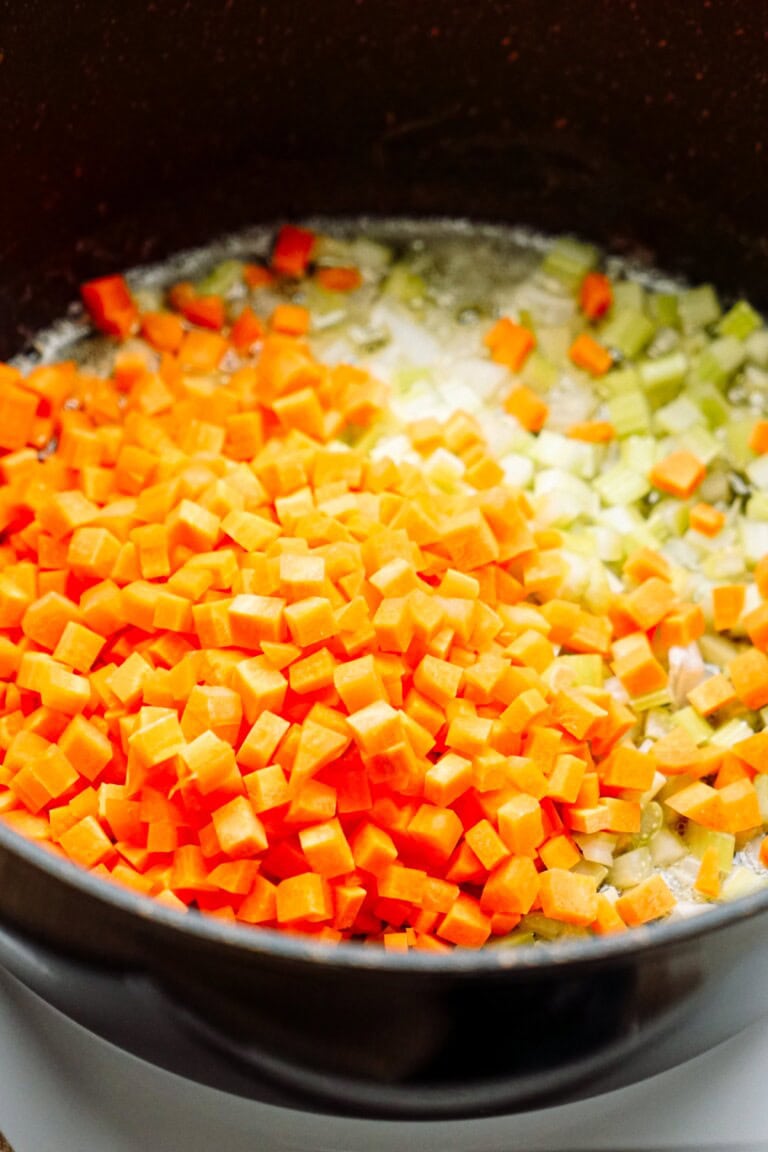carrots and celery sautéing in a skillet