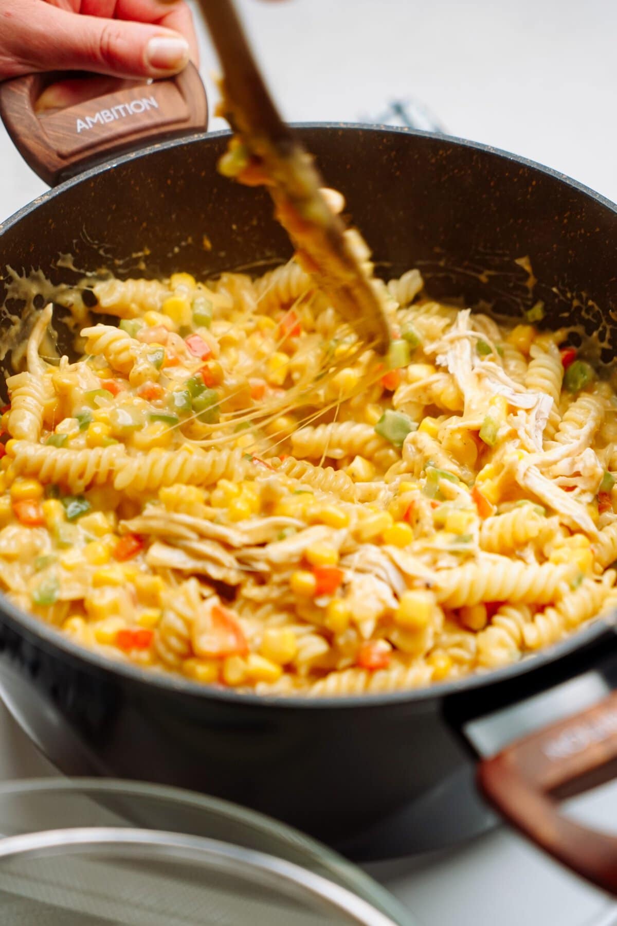 chicken pasta stirred together in a pot 
