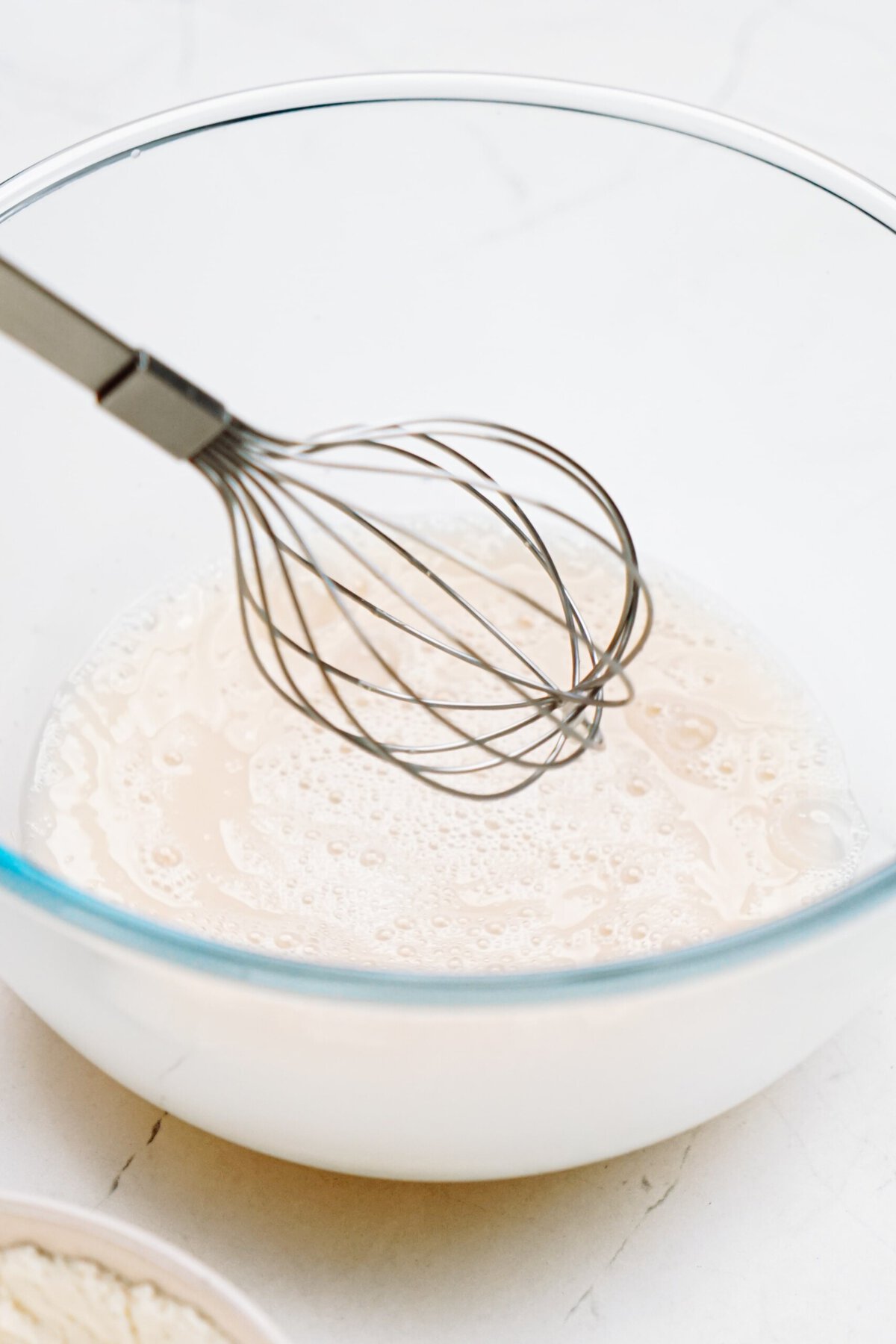 whisking water and yeast together