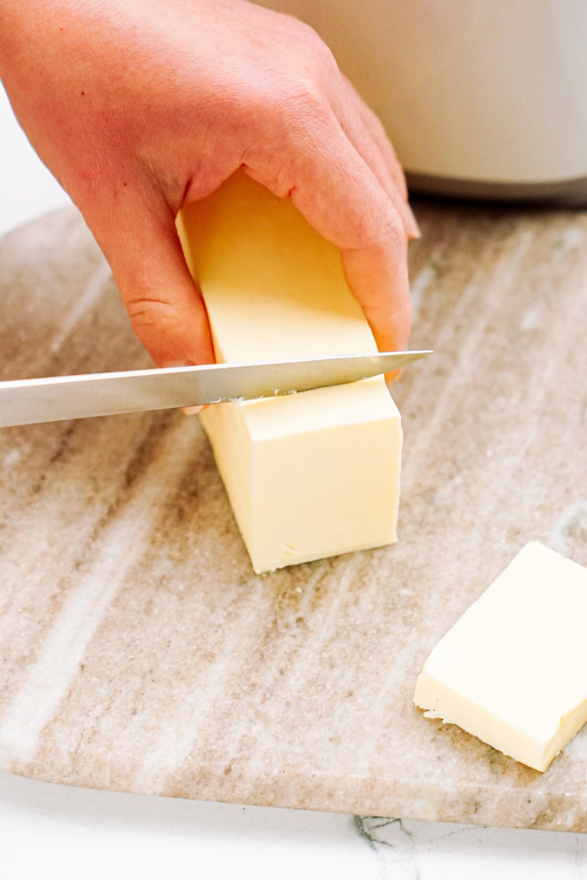 a person cutting butter