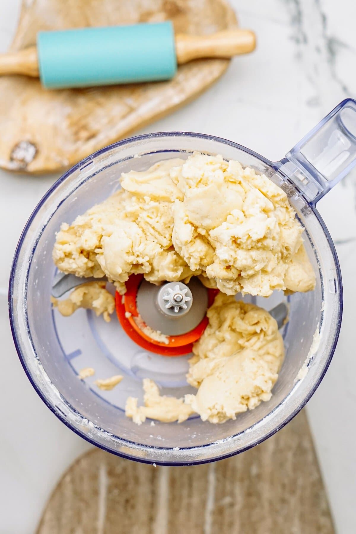 adding water to the dough mixture in a food processor 