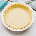 butter pie crust in a pie plate on a tablescape