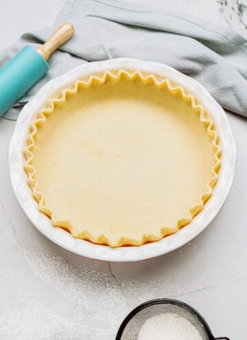 butter pie crust in a pie plate on a tablescape