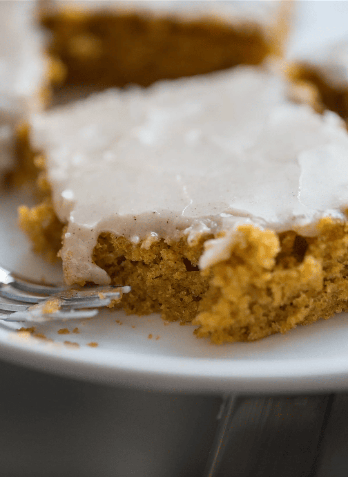 pumpkin bars on plate with fork, bite taken out