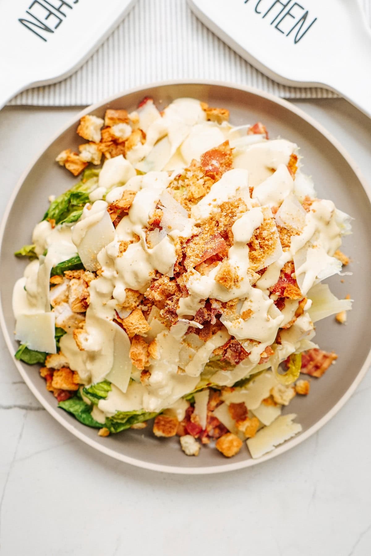 grilled chicken caesar salad assembled on a plate