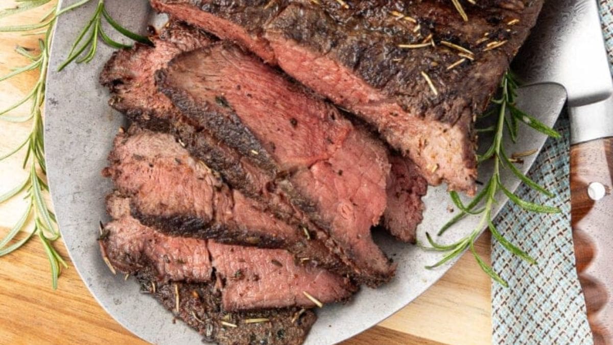 Sliced Herb Crusted Beef Sirloin Tip Roast Recipe. Photo credit Intentional Hospitality.