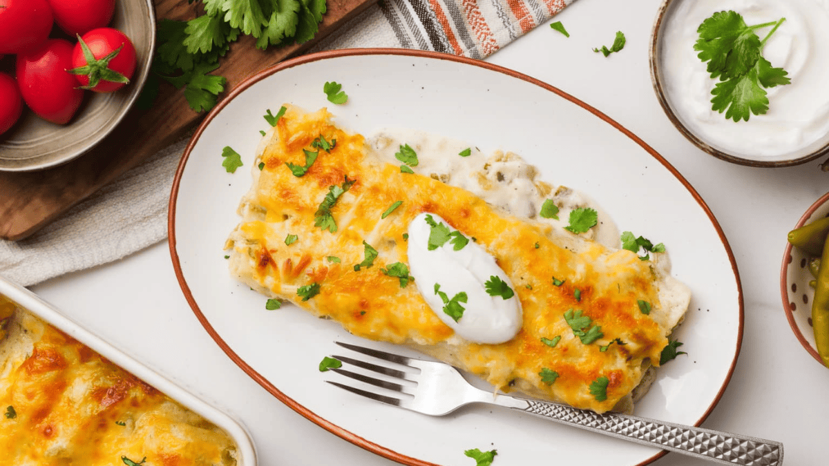 enchiladas and fork on a plate and tables cape